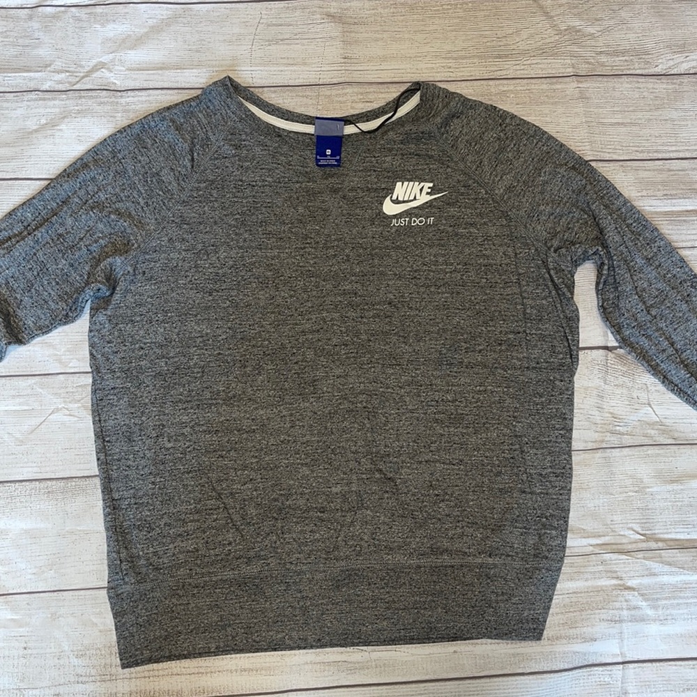 Woman’s grey Nike long sleeve shirt